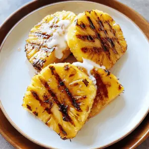 Transform your barbecue with this easy rum-soaked grilled pineapple! Bursting with tropical flavor and a touch of sweetness, this dessert is perfect for summer gatherings. Just soak fresh pineapple slices in a delightful rum mixture, grill until caramelized, and enjoy! Save this recipe for your next cookout or beach party – it's sure to impress!