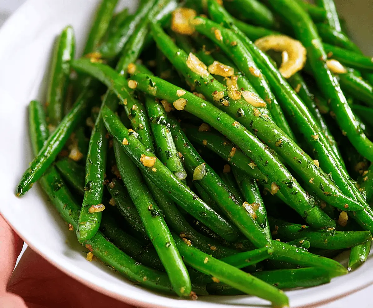 Delicious garlic butter green beans served as a healthy vegetable side dish.
