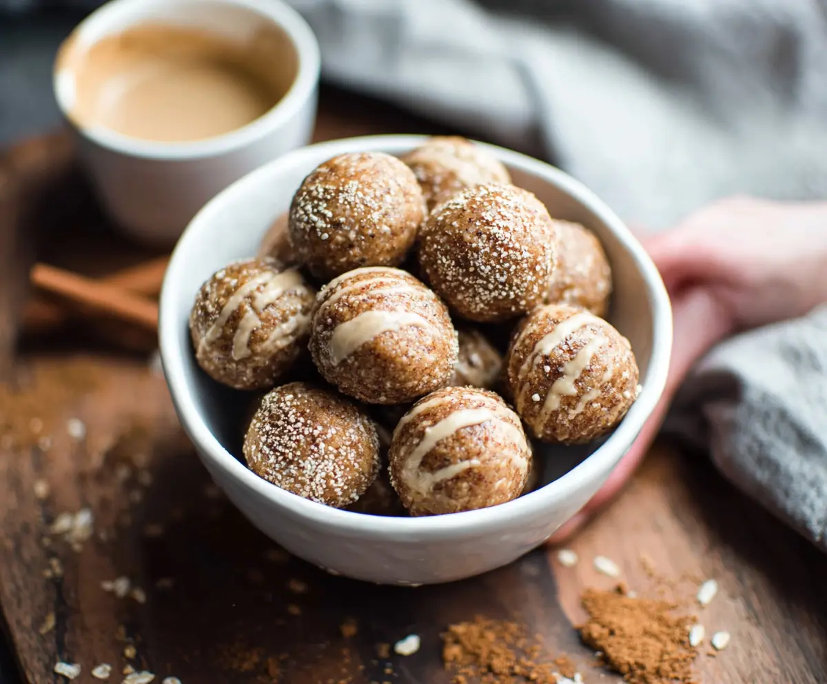 Delicious Cinnamon Roll Energy Bites with swirls of cinnamon and icing on a white plate.