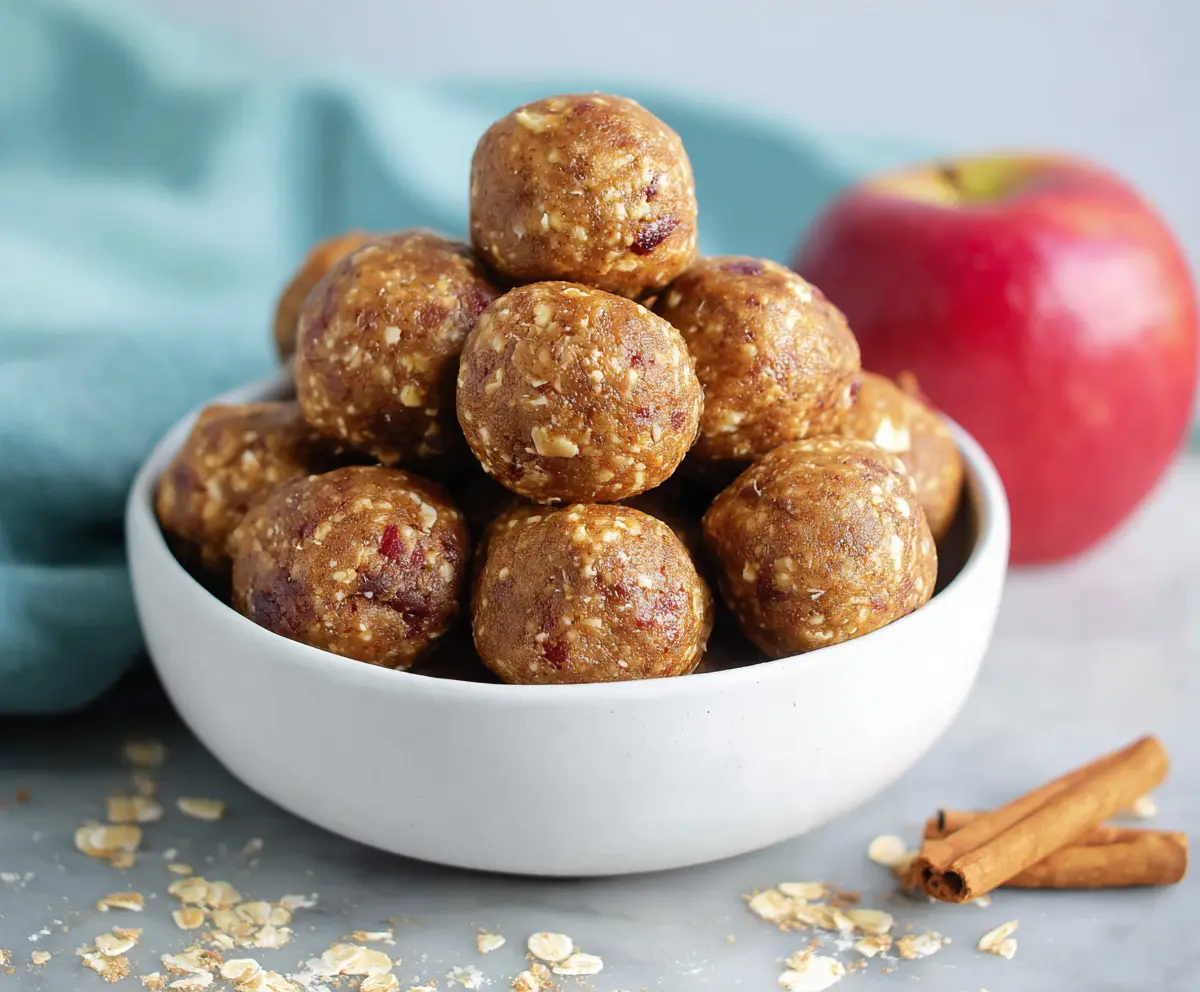 Delicious Apple Pie Protein Bites in a bowl, showcasing a healthy snack option with apple pieces and protein powder.