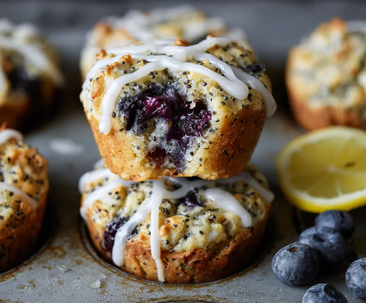 Fresh Blueberry Lemon Poppy Seed Sourdough Muffins on a rustic baking tray.