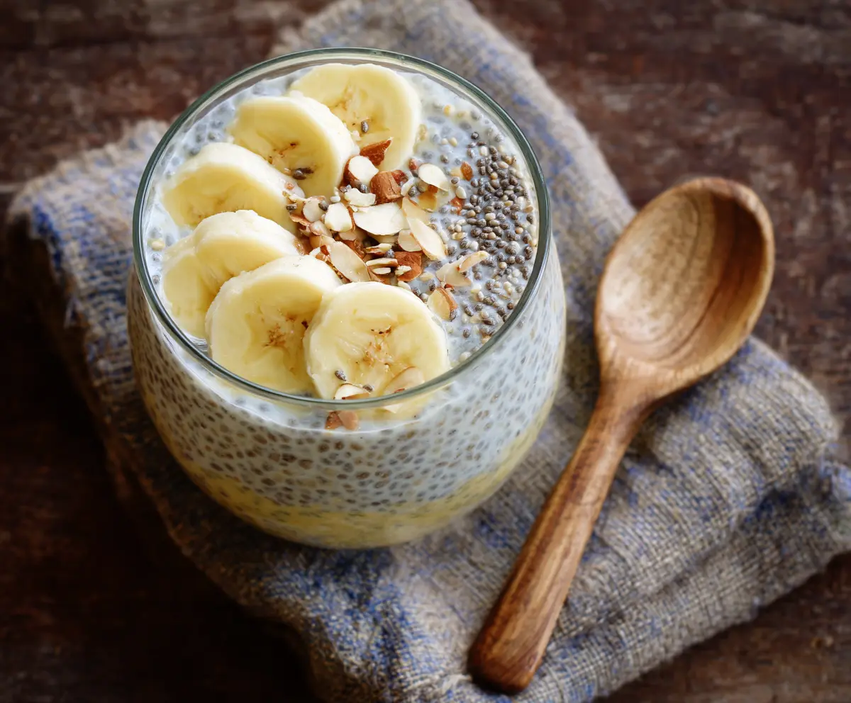 Healthy banana chia pudding in a glass bowl with fresh banana slices on top