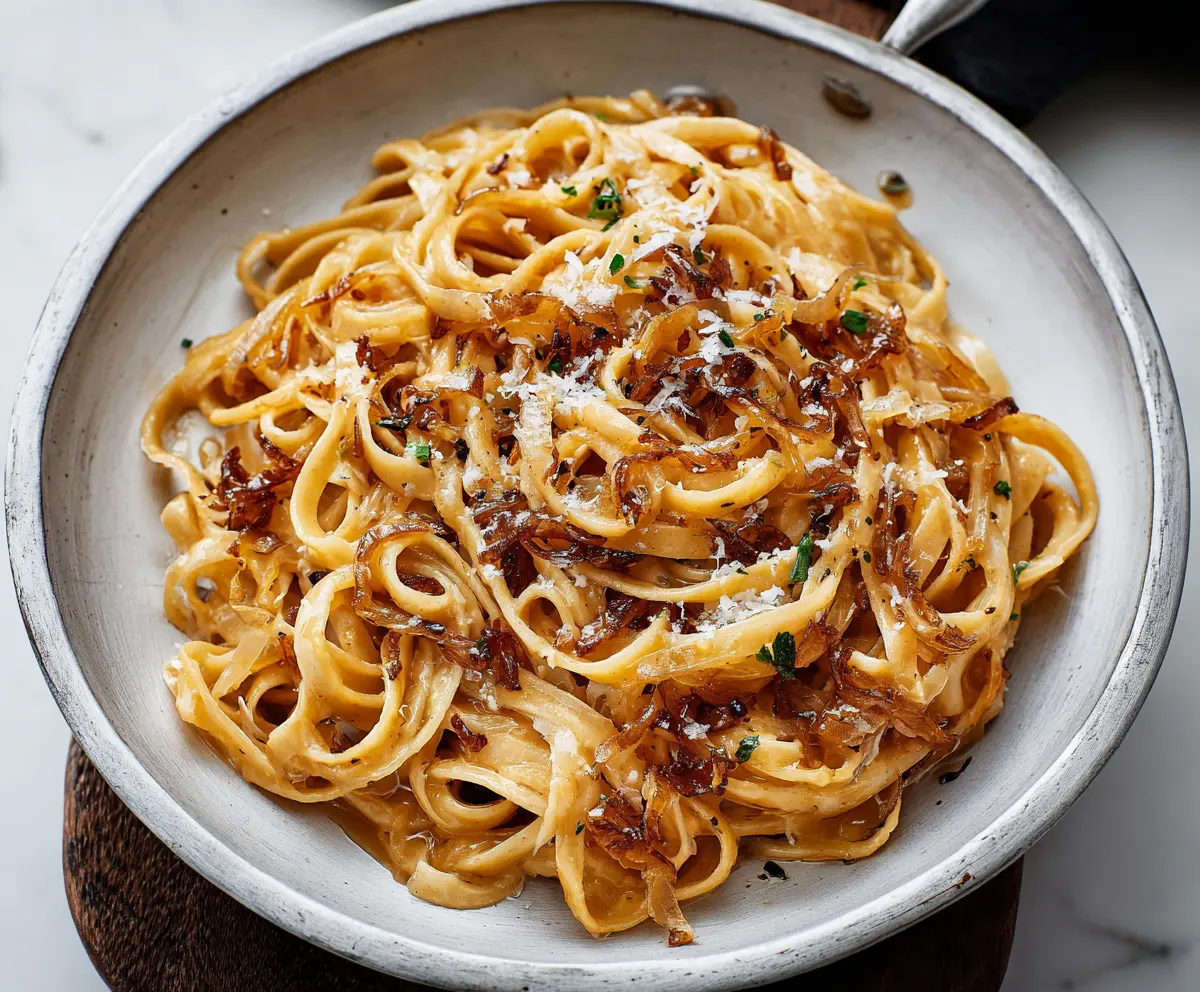 Delicious caramel onion pasta served on a plate, showcasing a savory and sweet flavor combination.
