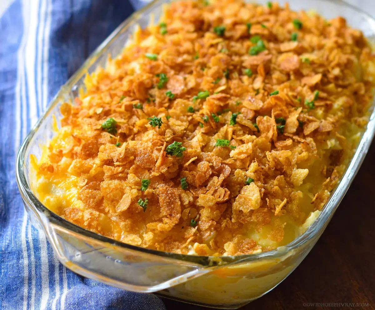 Delicious cheesy potatoes topped with crunchy corn flakes for a flavorful side dish.