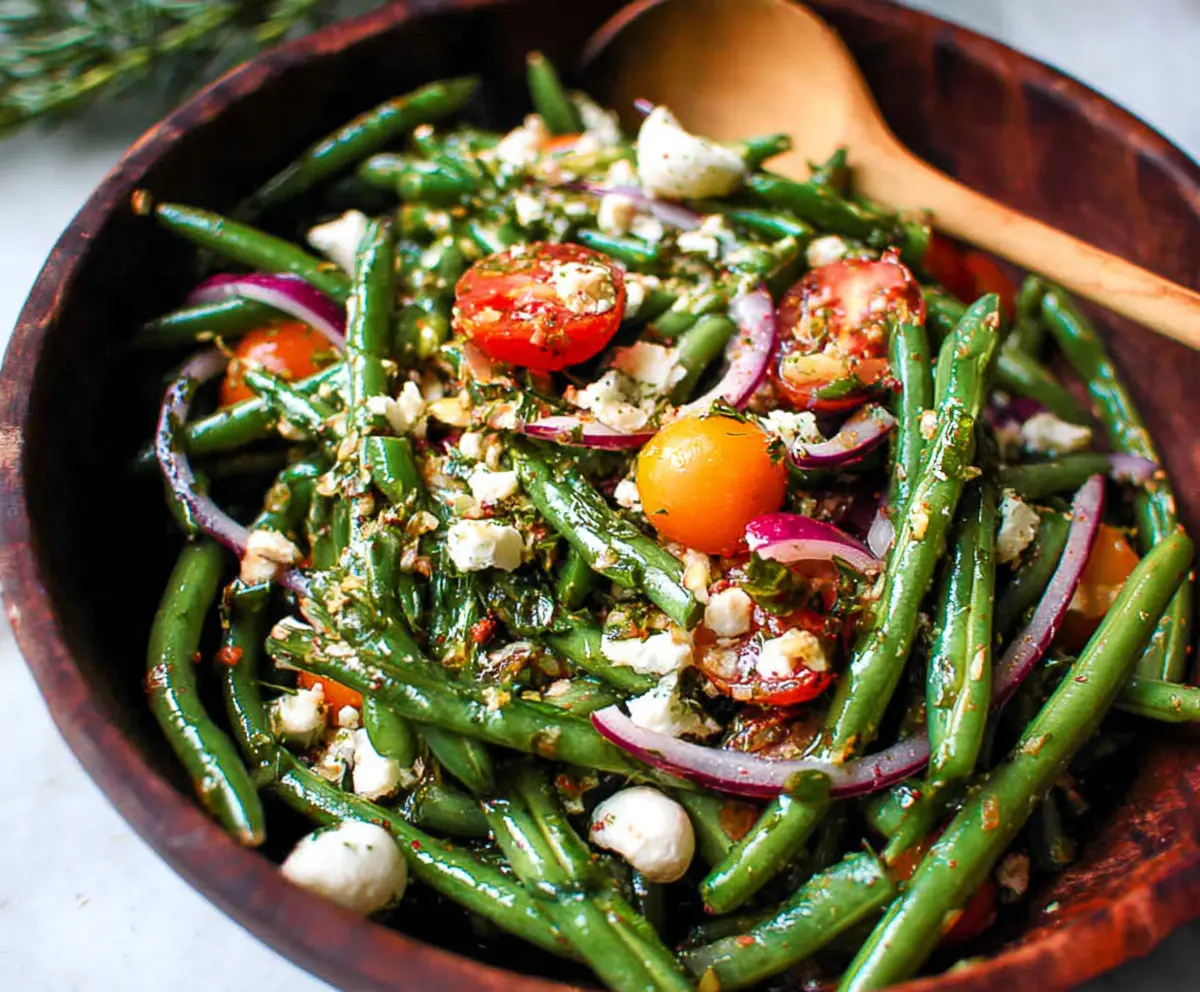 Fresh green bean salad with cherry tomatoes and feta cheese, perfect for summer meals